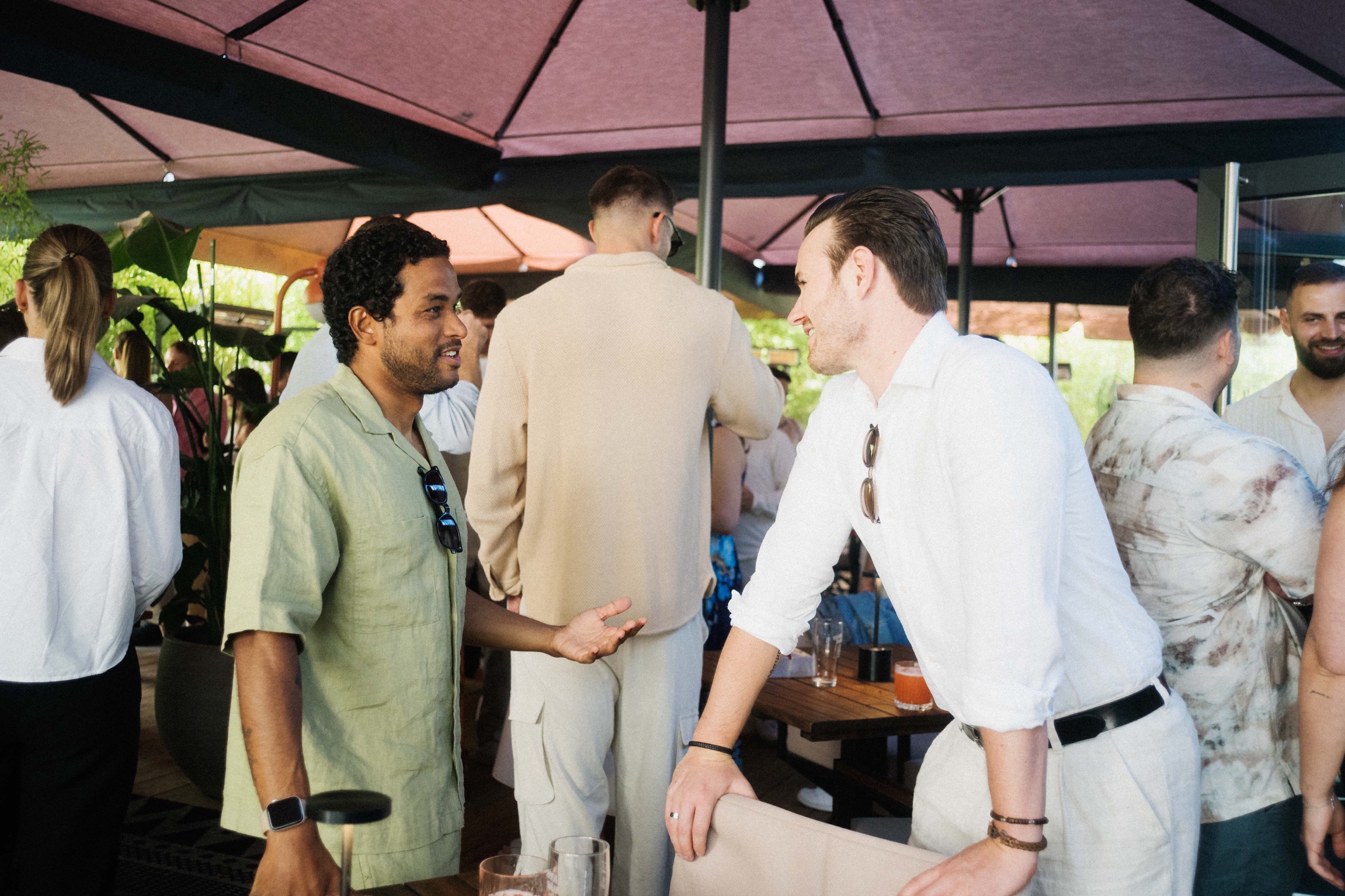 Matheus in conversation with a colleague at a company gathering